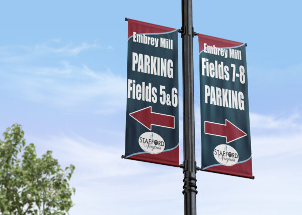 banners on a pole showing the direction of sports field