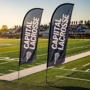 Custom lacrosse feather flags on sideline of outdoor field